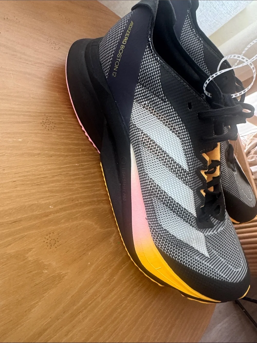 Adidas Adizero Boston 12 running shoe in the Core Black/Zero Metallic/Spark